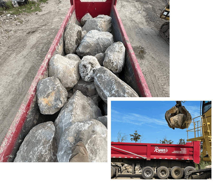Large granite rocks loaded on a red trailer and being lifted by a crane.
